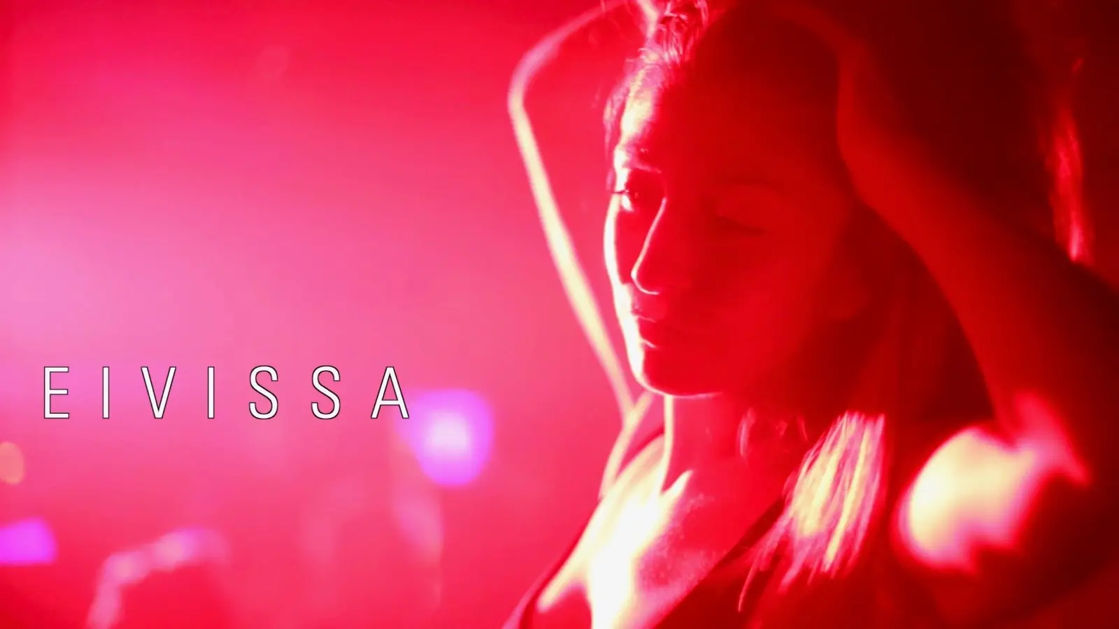 Scene from EIVISSA: a woman in red light